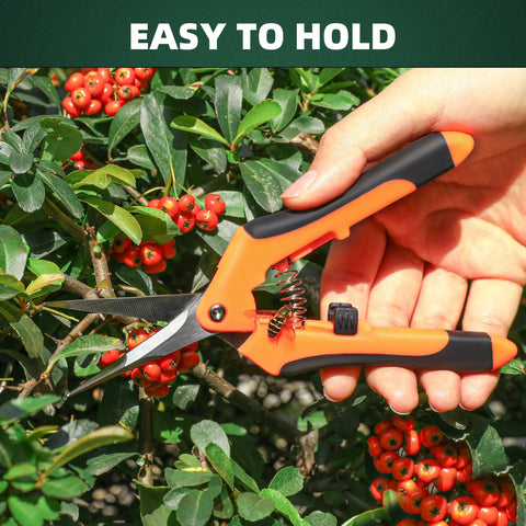 Hand holding orange garden pruning shear from Three Pack Garden Pruning Shears Set With Stainless Steel Blades, cutting branches.