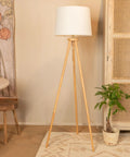 Dope Mid Century Modern Tripod Floor Lamp With Linen Shade In Natural And Cream Rubber Wood Base 63 Inch Tall 7 Foot Cord Rotary Switch Perfect For Living Room Or Bedroom next to a cabinet