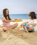 Children playing with Colorful Beach Shovels For Kids Set Of 4 Durable Plastic Sandbox Toys With Scoops For Toddlers at the beach