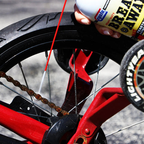 Breakaway Fast Penetrating Oil For Rusted Joints And Bolts being applied to a bicycle chain and wheel, NSF H2 certified.