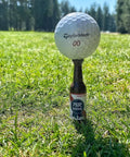 Beer Bottle Golf Tees Pack Of 6 For Golfers on a grass field holding a golf ball, virtually unbreakable recyclable plastic, 3-1/4 inches tall.