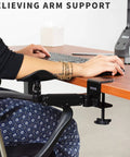 Two Pack Clamp Adjustable Armrests Transform Your Home Office Into A Hella Comfy Haven With Flexible 360 Rotating Elbow Support And Sturdy Steel Base Stand For Epic Desk Setups In Classic Black, shown installed on a desk.