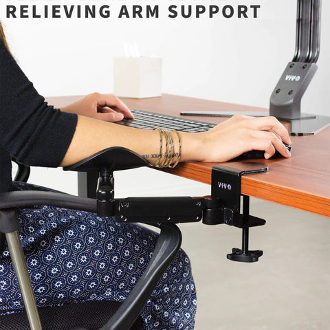 Two Pack Clamp Adjustable Armrests Transform Your Home Office Into A Hella Comfy Haven With Flexible 360 Rotating Elbow Support And Sturdy Steel Base Stand For Epic Desk Setups In Classic Black, shown installed on a desk.