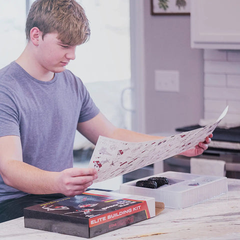 Teen with instructions for Beast Mode Erector Set Metal Model Kit For Adults Teens And Advanced Kids Build Cars Planes And Excavators