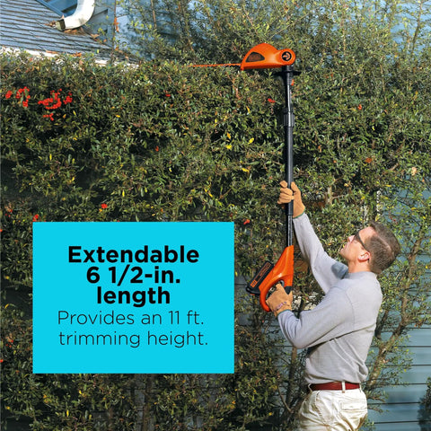 Man using 20V Max Cordless Pole Hedge Trimmer With 18-Inch Dual-Action Blade reaching 11 feet to trim tall hedges.
