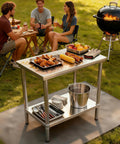 Stainless Steel Workbench With Dual Tier Storage Rack, 31.5 By 20 Inches, used for barbecue, with food items and utensils.