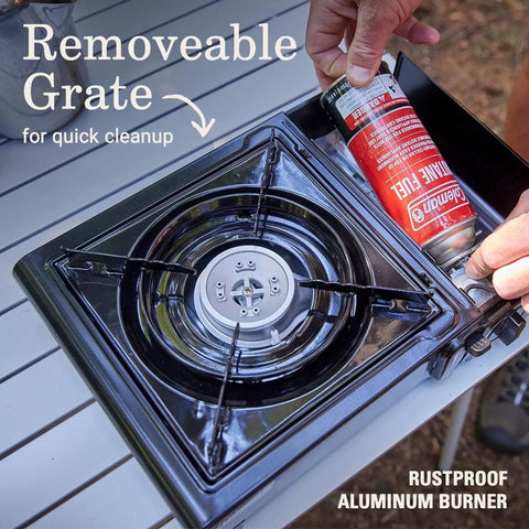 Portable Camping Stove With Carry Case And InstaStart Ignition showing butane canister being installed next to removable grate.