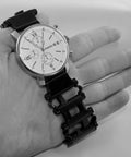 Watch Adapters for Tread and Tread LT in Black 16mm Lug Size Includes Pin Tool and Replacement Pins Lets You Swap Watch Bands Fast Apple Watch Compatible Adapters Patent Pending, displayed with a silver watch and black adapter in hand.