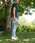 Man holding Heavy-Duty Tree Loppers With Steel Blade And 35.5 Inch Handle, Telescoping TeleCut 650-900 B Pruner For Cutting Green Branches And Shrubs, Extend Reach For High Limbs, A True Workhorse And Cuts Up To 1.65 Inches, German Made in garden