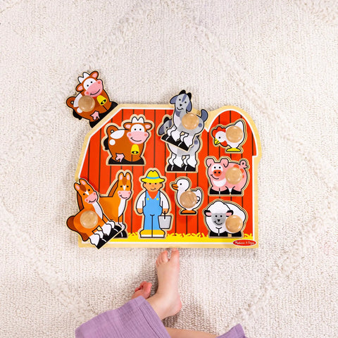 Farm Animals Jumbo Knob Puzzle For Toddlers Wooden Peg Puzzle For Early Learning Shape Recognition And Fine Motor Skills Cow Pig Horse On Colorful Barnyard Scene Kid Friendly Educational Toy For Ages 1 And Up with child's foot.