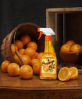 Keep Your Wood Looking Crisp And Protected With This Real Orange Oil Polish That Hits Different On Tables And Cabinets Delivering A Smooth Dime Shine While Blocking Daily Wear And Tear For Sure. Image of a spray bottle on a wooden table surrounded by fresh oranges.