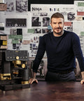 Top Shelf All In One Espresso Machine Featuring Built In Grinder And Hands Free Frother For Crisp Cold Brew And Fresh Drip Coffee Big Time Black Gold Edition with designer David Beckham.