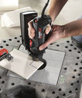 User operating the Badass Job Site Ready 6 Amp Roto Spiral Saw Kit With Variable Speed 15000 To 30000 Rpm on tile.