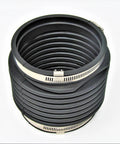 Overhead view of black ribbed marine exhaust hose with two silver hose clamps.