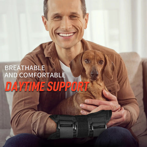 Man wearing wrist brace for carpal tunnel and night time pain relief with splints, holding a dog, showing daytime support.