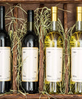 Wine bottles in a wooden crate with straw, part of the Wine Sealer Kit With Cork Stoppers And PVC Heat Shrink Capsules For Resealing Open Bottles, 100 Pack Including 50 Cork Tops And 50 Capsules, Perfect For Home Cellars, Cruises, Parties, Weddings And Holidays