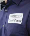 Top Shelf Name Badge Labels Compatible With Labelwriter Printers Featuring Killer Peel And Stick Adhesion Bright White Color 2.25 By 4 Inches Sheets 250 Count No Sweat Thermal Printing on a shirt.