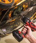 Using Beefy 20V Cordless Impact Wrench Kit With 300 Ft Lb Torque on an orange lawn mower blade underside.