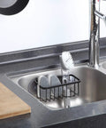 NeverRust Deluxe Kitchen And Bathroom Sink Sponge Holder Organizer installed in a sink with adhesive mount, matte black, 7.4x3.3x2.75 inches.