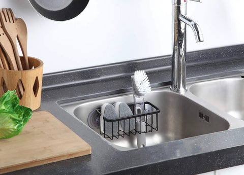 NeverRust Deluxe Kitchen And Bathroom Sink Sponge Holder Organizer installed in a sink with adhesive mount, matte black, 7.4x3.3x2.75 inches.