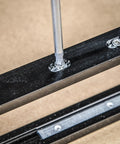 Close-up of screw being fastened into the aluminum rail of Adjustable Modular Door Hinge Router Jig For Timber Doors.