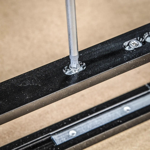 Close-up of screw being fastened into the aluminum rail of Adjustable Modular Door Hinge Router Jig For Timber Doors.