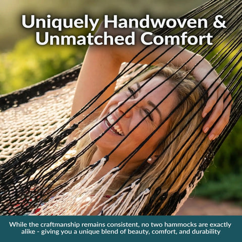 Smiling person relaxing in XXL Handwoven Mayan Double Hammock For Outdoor Use With Thick Cord 156 Inch Wide 90 Inch Deep And 625 Pound Capacity Heavy Duty Outdoor Hammock In Black And Natural.
