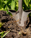 Compact Perennial Garden Shovel With Serrated Blade For Precise Digging and Root Cutting in soil, close-up view
