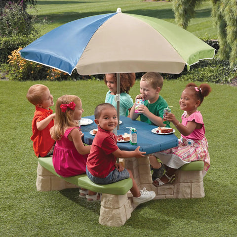 Six toddlers seated at the Naturally Playful Kids Picnic Table With Removable Umbrella For Indoor And Outdoor Use, Blue And Green