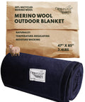 Merino Wool Blend Blanket With Fifty Percent Wool, Machine Washable Throw For Camping And Survival Gear, Travel Blanket For Camper Vans And Cars, Thermal Insulation, Large 85 By 47 Inches In Juniper, displayed rolled with packaging.