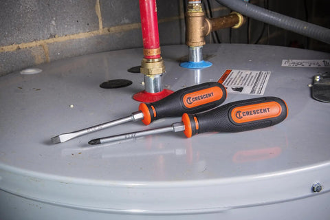 Two Piece Dual Material Screwdriver Set With Phillips Two By Four Inches And Slotted One Quarter By Four Inches Durable Ergonomic Grips Handy For Home DIY Projects And Everyday Fixes on a metal tank surface.
