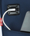 smart underseat carry-on with USB charging port close-up, navy fabric, showing a USB cable connected to a phone in pocket compartment