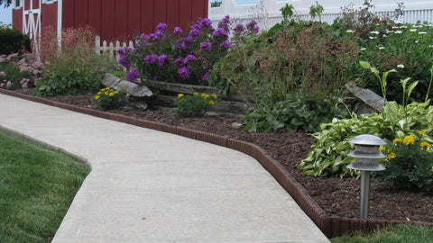 Brown Lawn And Landscape Border Edging For Garden Beds And Walkways With Flexible Design installed along a curved path
