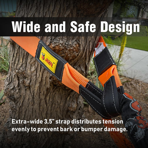 Heavy Duty Tree Saver Strap Three Point Five Inch By 8 Foot With 36000 Lbs Break Strength Beefed Up Polyester Webbing Tow Strap For Winch And Off Road Recovery Looped Ends For Truck And Jeep attached around a tree trunk, highlighting wide and safe design.
