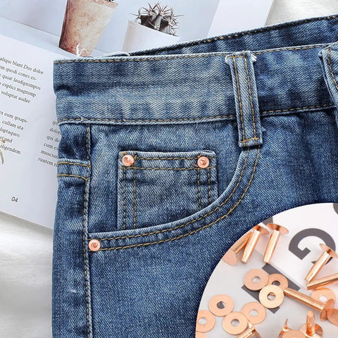 Close-up of jeans displaying copper rivets from the Copper Rivets And Burrs Kit, 20 Pieces In 14mm And 19mm for DIY leather crafting.