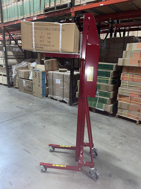 Full Size Manual Hand Winch Work Positioner Lift Truck For Warehouse Steel Frame with polyurethane casters, loaded with boxes.