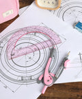 6 Inch Compass And Protractor Gear For Geometry And Drafting, Precision Circle Maker With Sturdy Grip And Smooth Handling, Ideal For Classrooms, DIY Projects, Art And Design, Arc And Circle Creation. Pink compass and protractor set on drafting paper