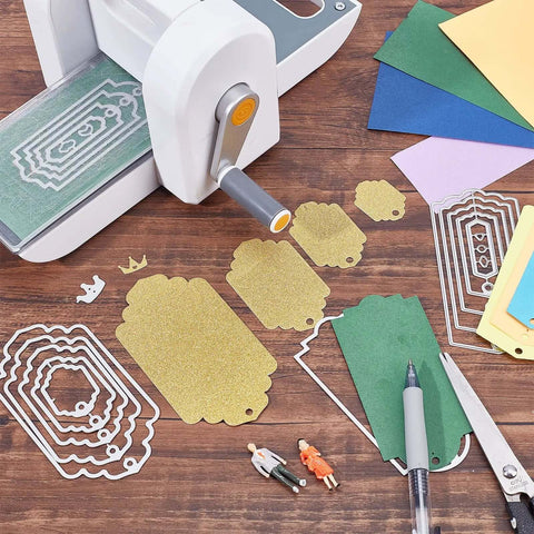 Five set of thirty six bookmark die cuts and tag dies with embossing stencils for scrapbooking, displayed next to a cutting machine.