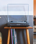 Crosley T400D Black Fully Automatic 2-Speed Turntable With Built-in Bluetooth Speaker Output And Preamp on a wood stand with vinyl records.