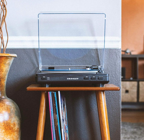Crosley T400D Black Fully Automatic 2-Speed Turntable With Built-in Bluetooth Speaker Output And Preamp on a wood stand with vinyl records.