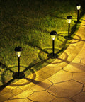 Eight Pack Solar Pathway Lights Waterproof Outdoor Garden Yard Landscape Walkway Driveway With Auto On Off And Energy Saving Warm White Glow Weather Resistant Easy Setup illuminating a walkway