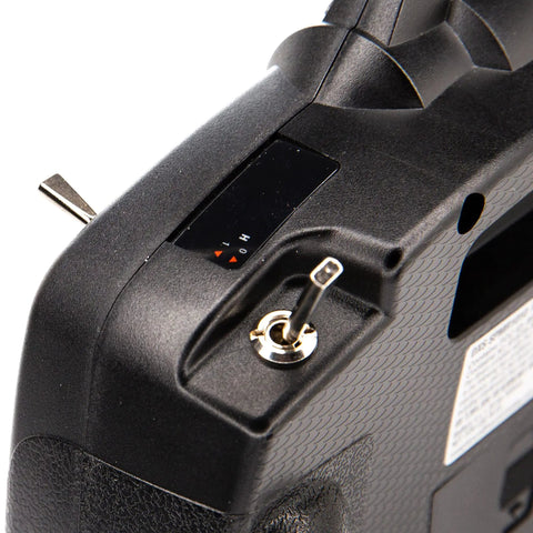 Close-up of DXS Transmitter With AR410 Receiver Delivers Smart Technology Telemetry, ergonomic grip with toggle switch detail.
