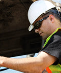 Man wearing XT1-21 Extremis Full Black Frame Safety Glasses With Smoke Anti Fog Lens, construction worker with hard hat and vest