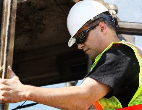 Man wearing XT1-21 Extremis Full Black Frame Safety Glasses With Smoke Anti Fog Lens, construction worker with hard hat and vest