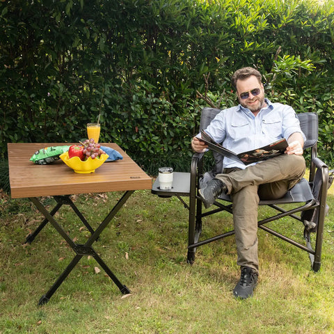 Man relaxing outdoors with Oversized Directors Chair With Foldable Side Table And Detachable Pocket Heavy Duty Camping Chair Up To 600 Lbs Weight Capacity Gray For Tailgates And Backyard Chill