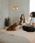 Dope Industrial Floor Lamp With Gold Finish For Rustic Farmhouse Style Arc Standing Lamp in living room with two people and dogs