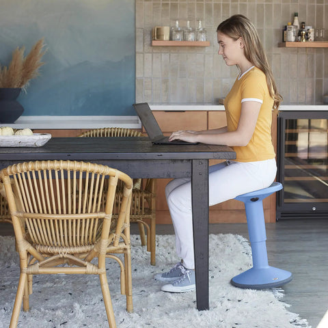 Woman using SitWell Wobble Stool With Adjustable Height For Active Seating In Classrooms And Libraries, powder blue version