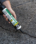 Low VOC Blacktop Asphalt Sealant Crack Filler No Heating Required Easy Crack Fix Long Lasting Repair For Driveways Parking Lots And Outdoor Courts Resists Gasoline Salt Oil And Grease being applied to asphalt crack