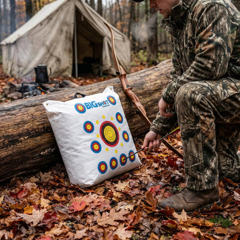 Beast-Size Outdoor Archery Target Bag 36 By 30 By 11 Inches beside a log, camo-clad archer in forest setting.