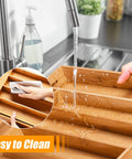 Sleek Expandable Bamboo Drawer Organizer For Kitchen Flatware Holder With Hassle Free Adjustable Compartments being washed under running water.